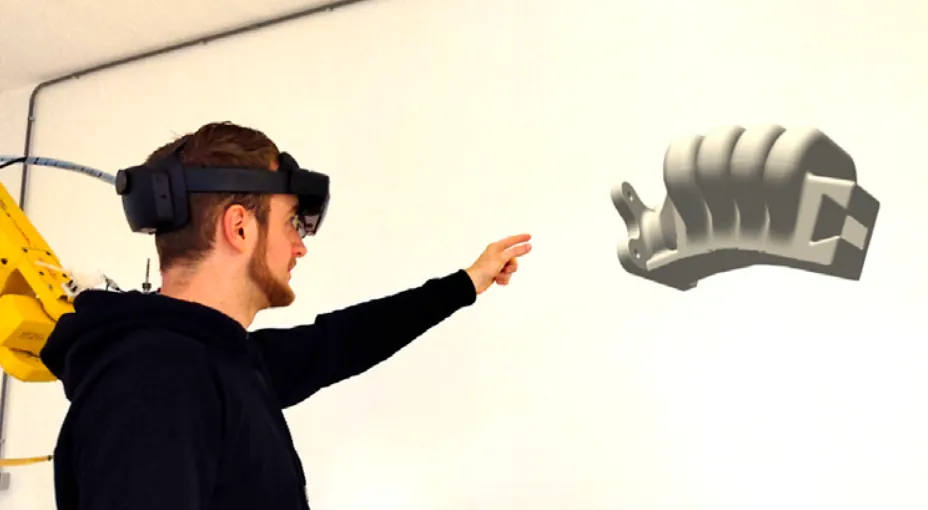 Onderzoeker met een XR-headset naast een gerenderde soft robotic manipulator